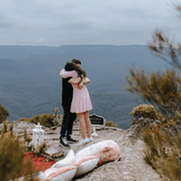 Couple hugging at a luxury picnic in the Blue Mountains